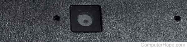 Built-in webcam on laptop - small dark square with dark circle inside
